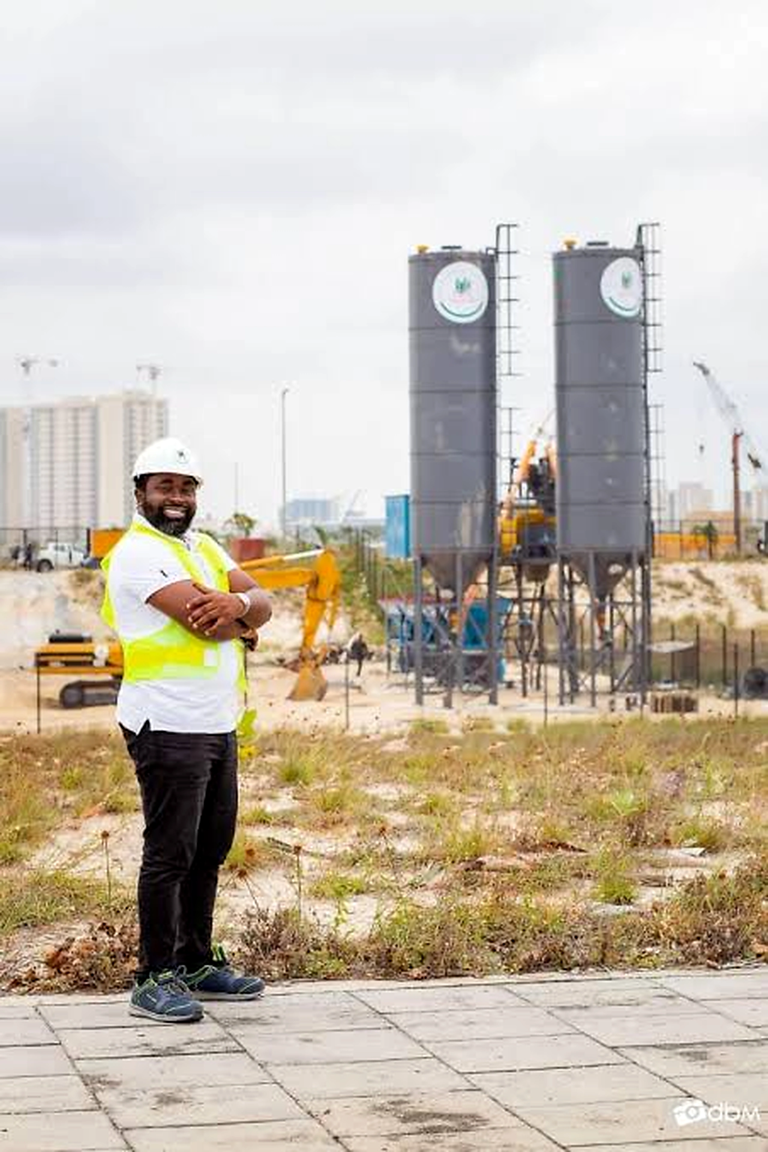 Olukayode Olusanya wearing a hard hat and safety vest at a construction site